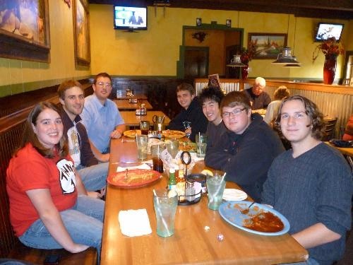 Photo of trombone students around table at dinner during Fall 2009.